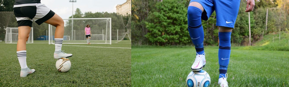 Person in blue football kit standing on football on a grass field. Person on a football field in white and black kit wearing white shoes with a white and gold football with a goalie in a pink tshirt.